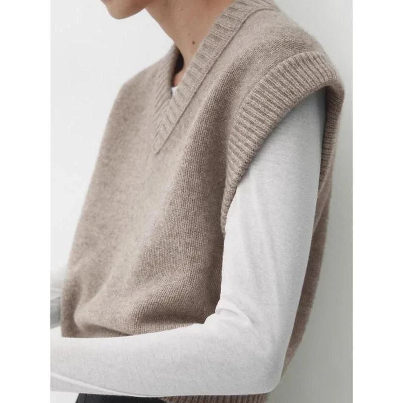 A cosy and stylish women's knitted vest in a neutral colour, with a V-neck design and sleeveless silhouette for easy layering.