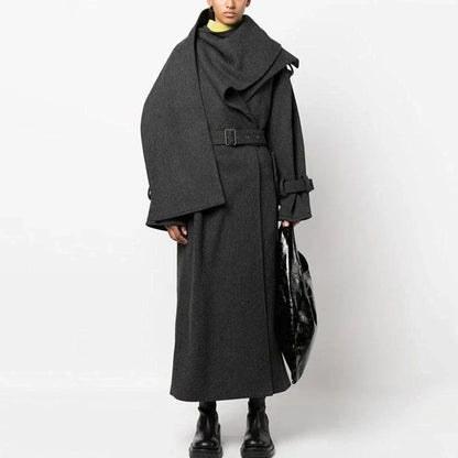 A stylish trench coat with a cosy scarf collar, featuring a patchwork design and adjustable belt for a customised fit.