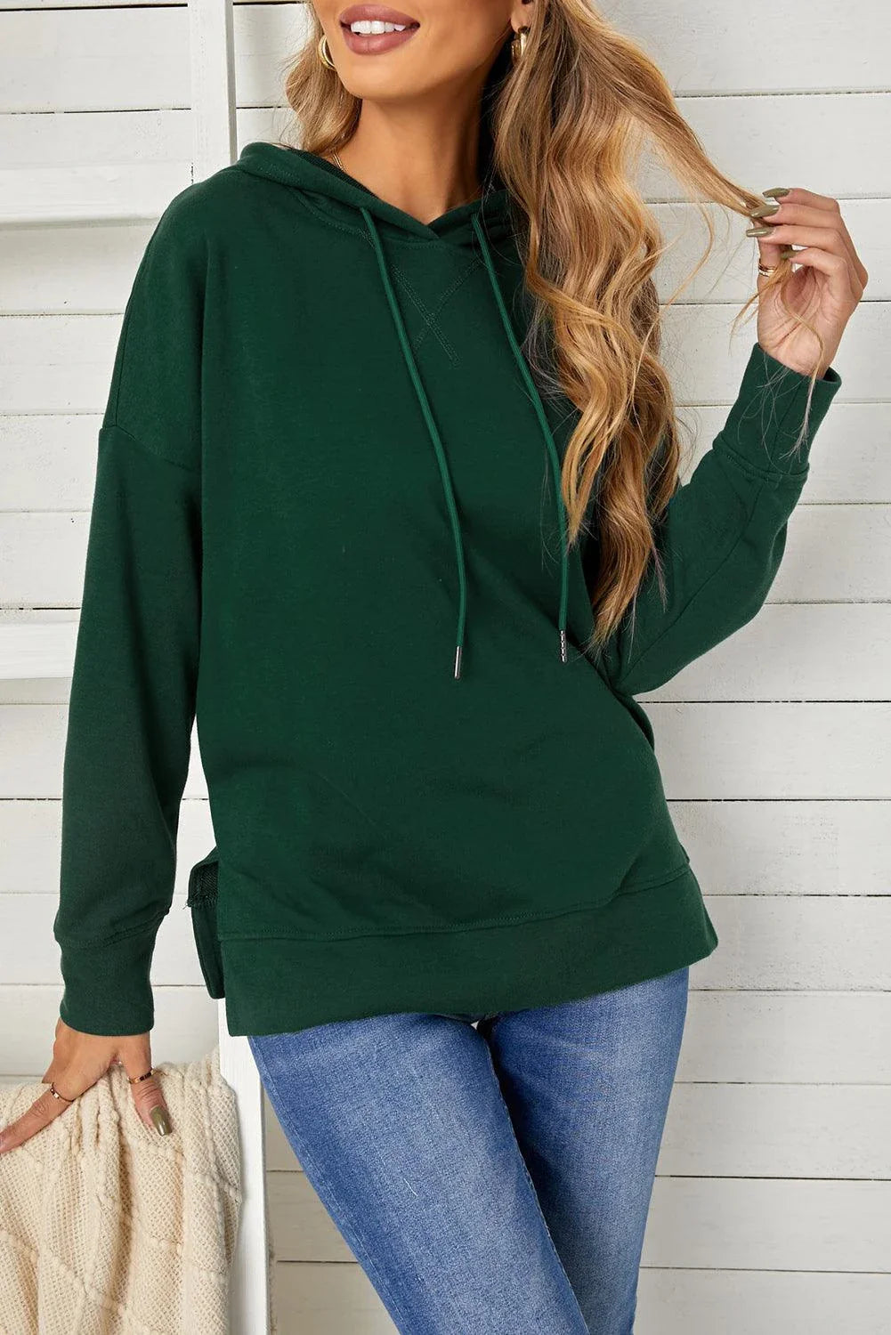 Comfortable drop-shoulder hoodie with stylish slit in green color, featuring a soft, stretchy fabric blend and practical drawstring closure