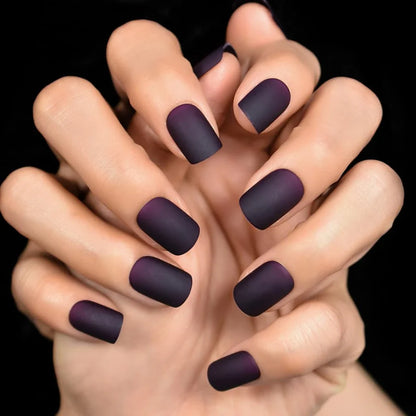 Matte purple and black squoval fake nails with a sleek, salon-quality design