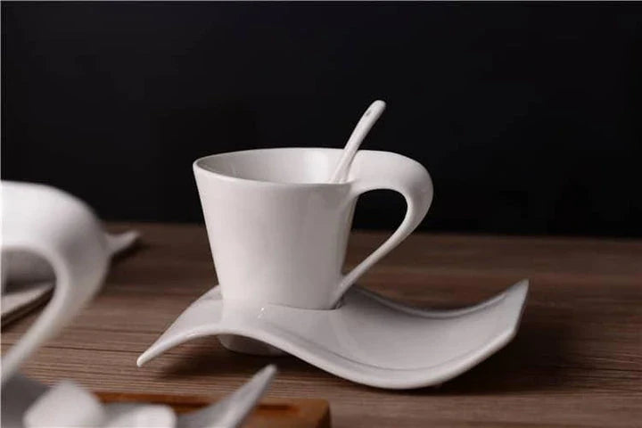 Stylish wavy ceramic coffee mug with matching saucer, available in various sizes and materials, designed in New Zealand for an elevated coffee experience.