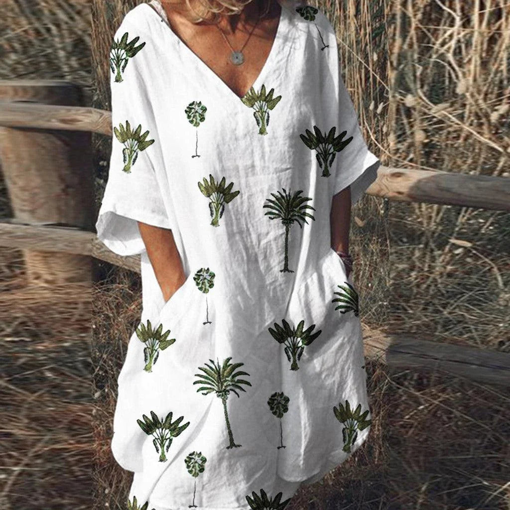 Vibrant leaf print casual dress with V-neck and flared silhouette, perfect for the Kiwi lifestyle