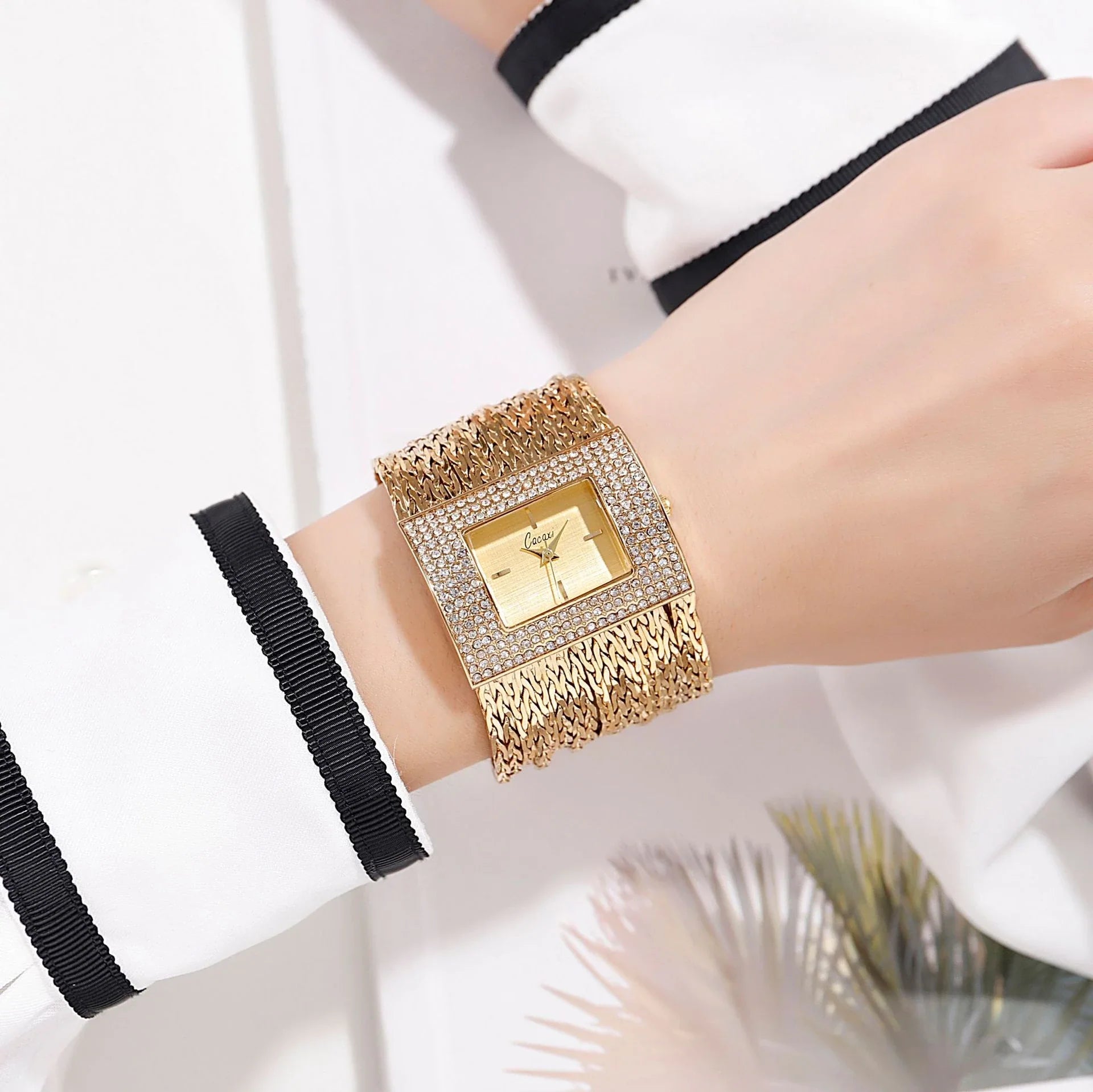 A gold-toned ladies' quartz watch with a rhinestone-encrusted face and a comfortable alloy strap