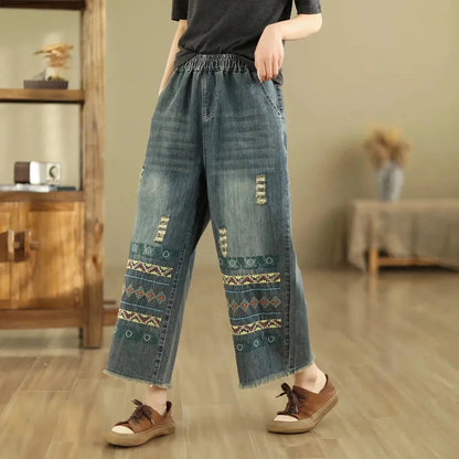 Vintage-inspired embroidered wide-leg jeans in a relaxed, bohemian style with a high-waist design and elastic closure for a personalized fit