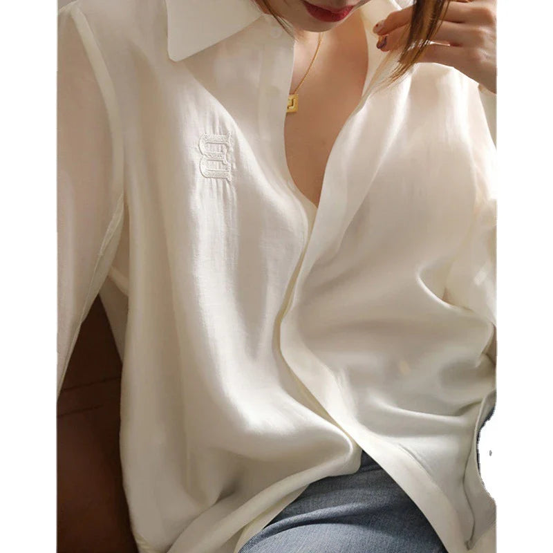 A stylish and comfortable white chiffon blouse for Kiwi women, featuring a classic cardigan design and versatile, high-quality construction.