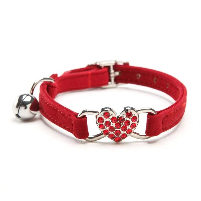 A stylish cat collar made of premium velvet material, featuring a heart-shaped charm and jingle bell for a playful touch.