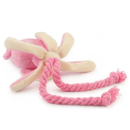 Cuddly pink squid-shaped plush toy for dogs, made of soft fleece material for snuggles and play