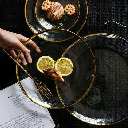 Elegant glass plates with a shimmering gold rim, perfect for formal dinners or casual meals.