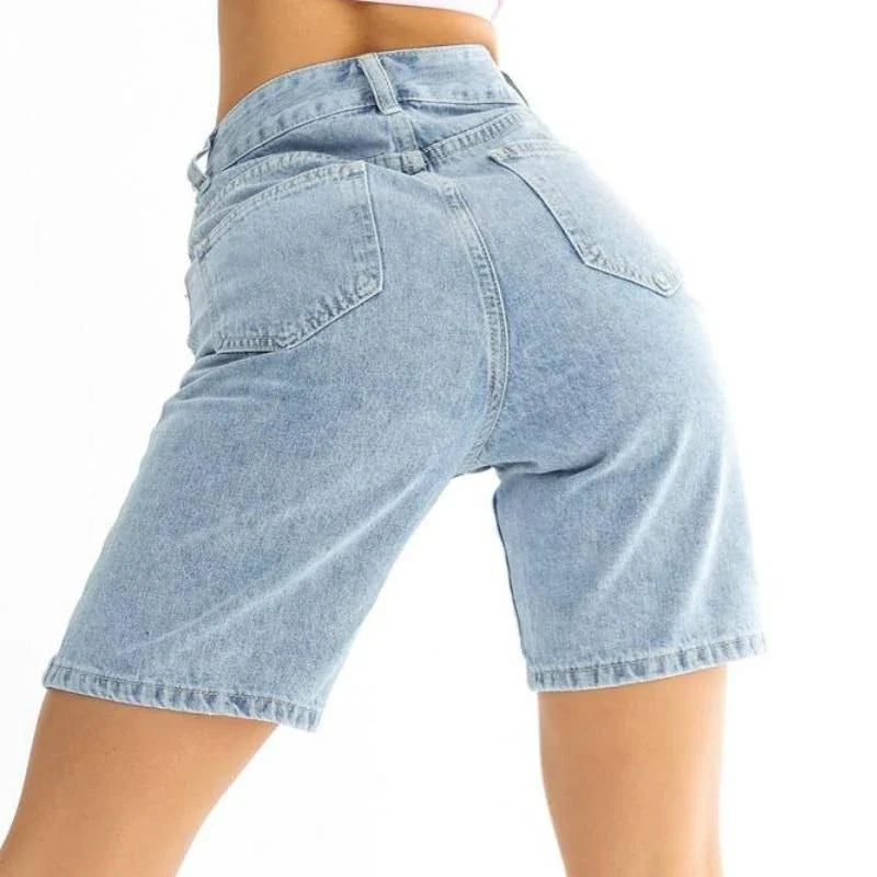 Classic blue knee-length denim shorts with high-waisted design, button fly closure, and wide-leg silhouette