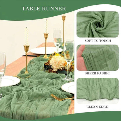 A green boho-style cheesecloth table runner with a delicate, wrinkled texture that adds a touch of elegant charm to any table setting.