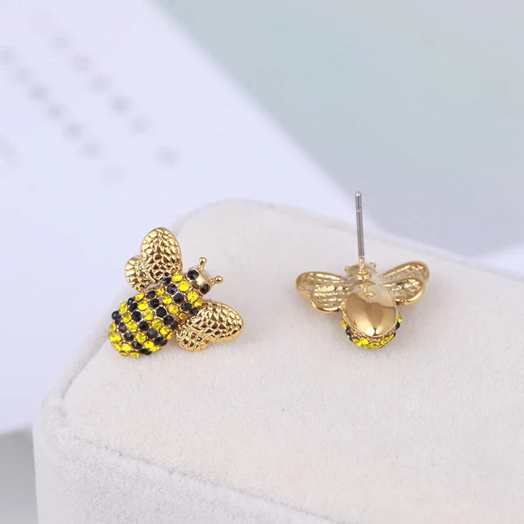 Elegant three-dimensional diamond bee stud earrings in a gold tone, featuring a sparkling design that adds a touch of whimsy and sophistication.