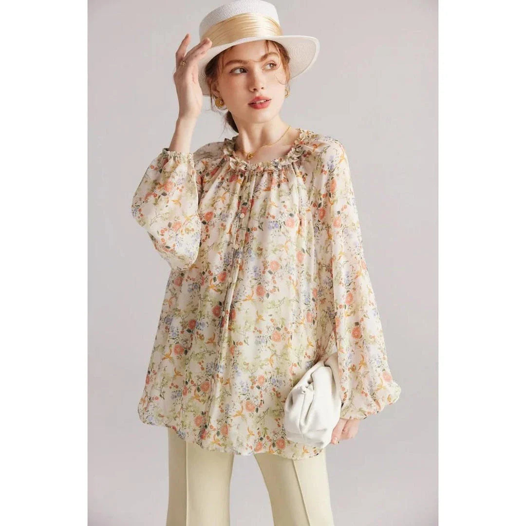 Elegant floral silk-blend blouse with ruffled details and relaxed raglan sleeves