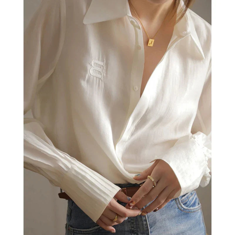 A stylish and comfortable white chiffon blouse for Kiwi women, featuring a classic cardigan design and versatile, high-quality construction.