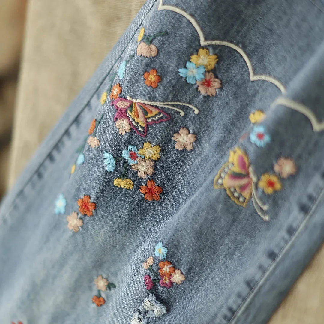 Embroidered wide-leg denim pants with a high-waist design and elastic closure, perfect for Kiwi fashion.