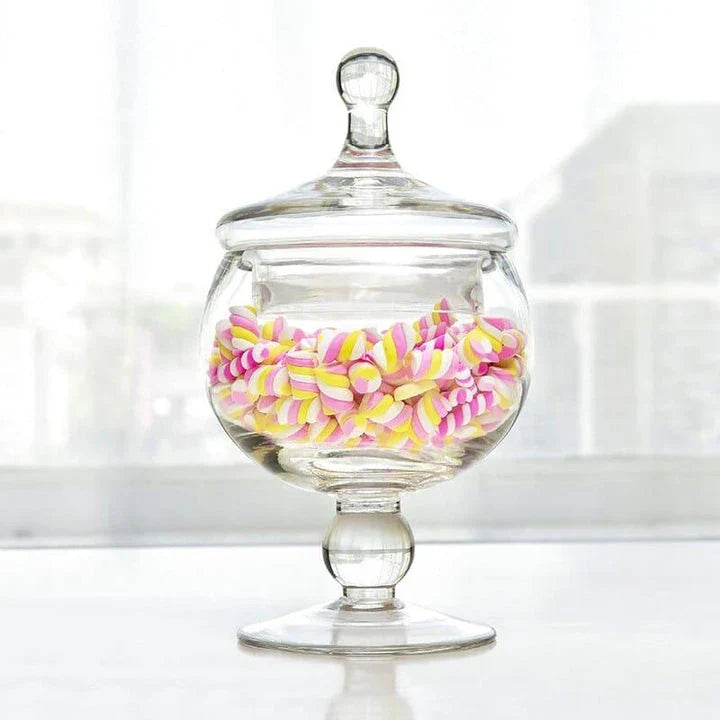A transparent glass candy jar with a secure lid, perfect for serving sweets and treats at a wedding celebration.