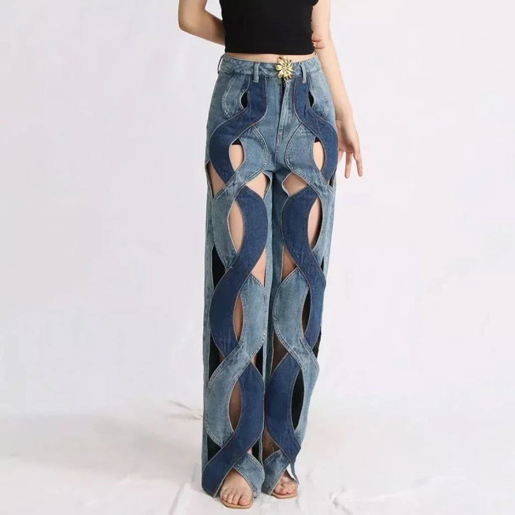 Stylish high-waisted floral distressed denim jeans with a button fly closure and a loose, comfortable fit