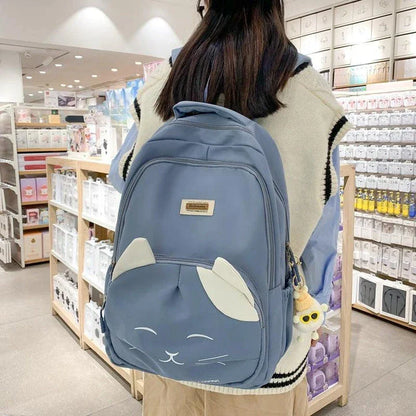 A stylish Japanese-inspired cat backpack with a large capacity, breathable nylon construction, and dedicated storage compartments for student essentials.