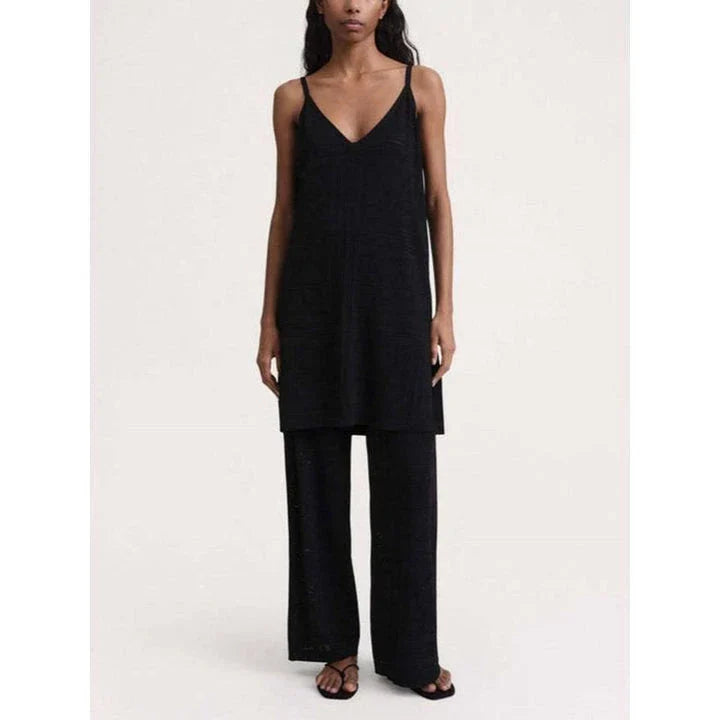 High-waist hollow-out knit trousers in a black color, featuring a straight, wide-leg cut and a sophisticated pattern