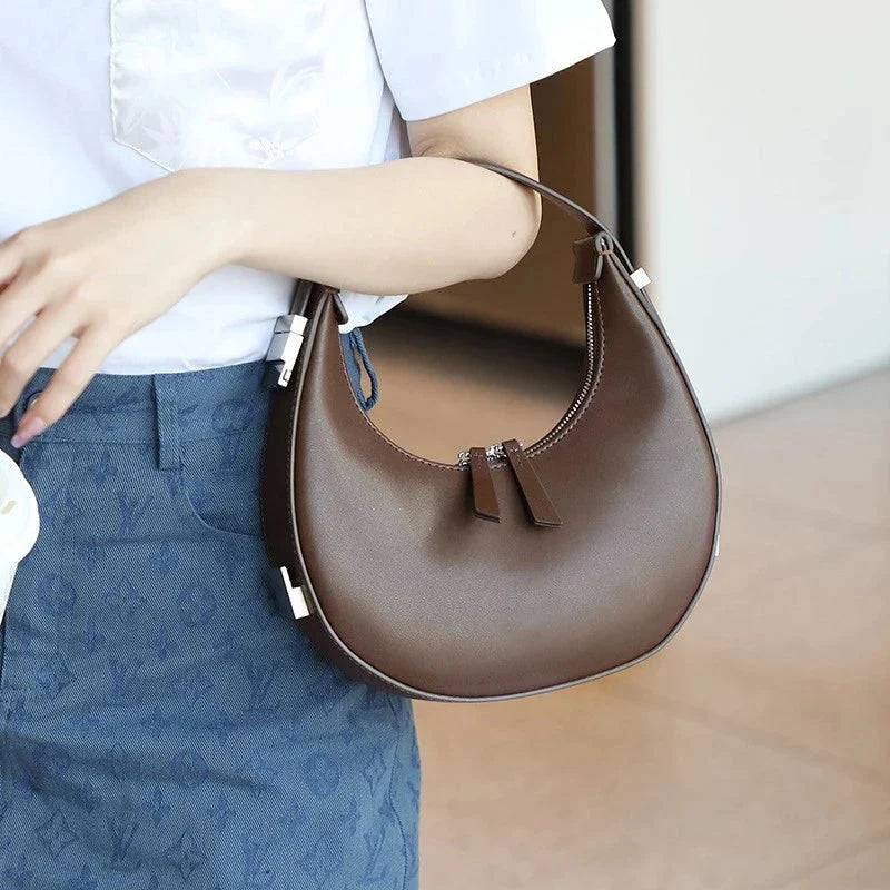 Elegant leather shoulder bag in a half-moon shape, perfect for Kiwi fashion