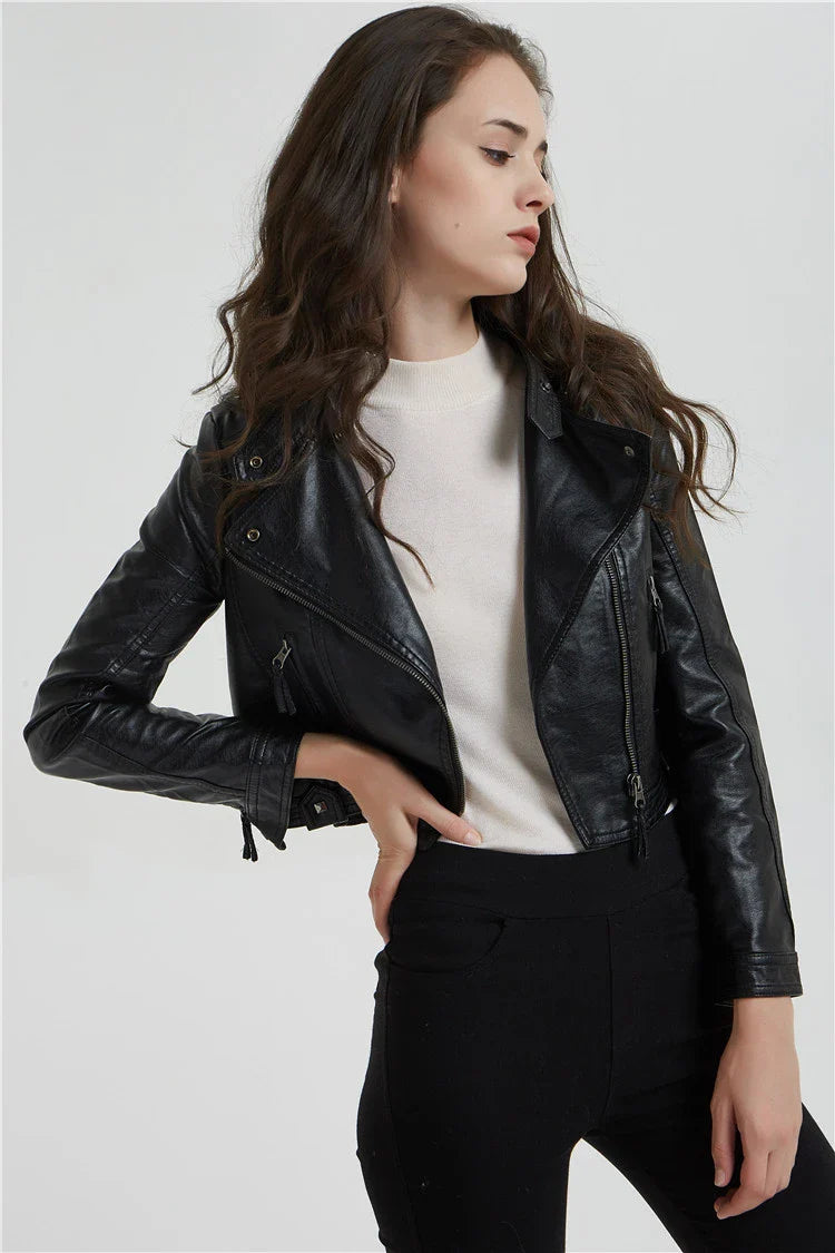 Trendha Women's Short Leather Jacket in Black, featuring a weathered finish and rivet detailing for a stylish, urban-inspired look