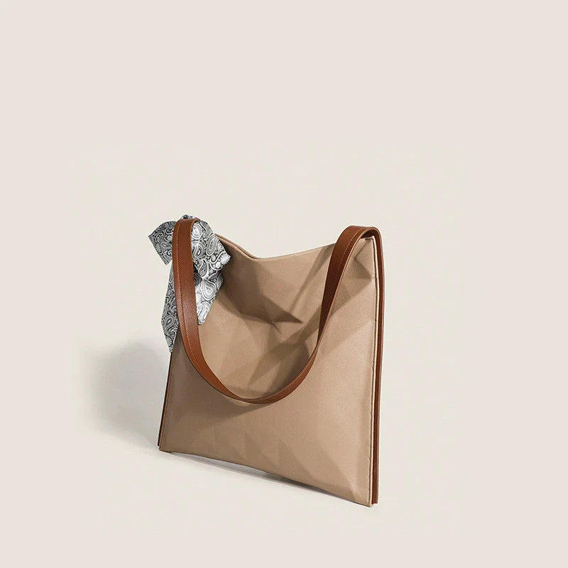 Stylish large-capacity tote bag with a geometric design, made from durable PU leather and featuring a spacious interior and convenient magnetic closure.