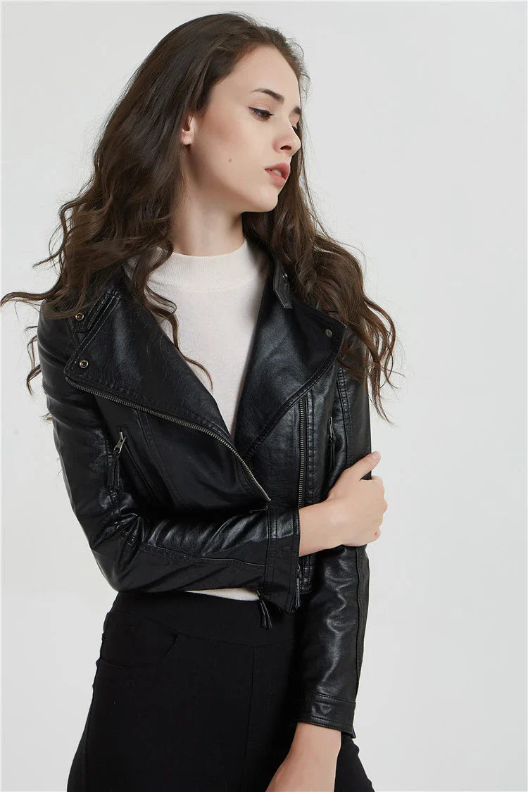 Trendha Women's Short Leather Jacket in Black, featuring a weathered finish and rivet detailing for a stylish, urban-inspired look