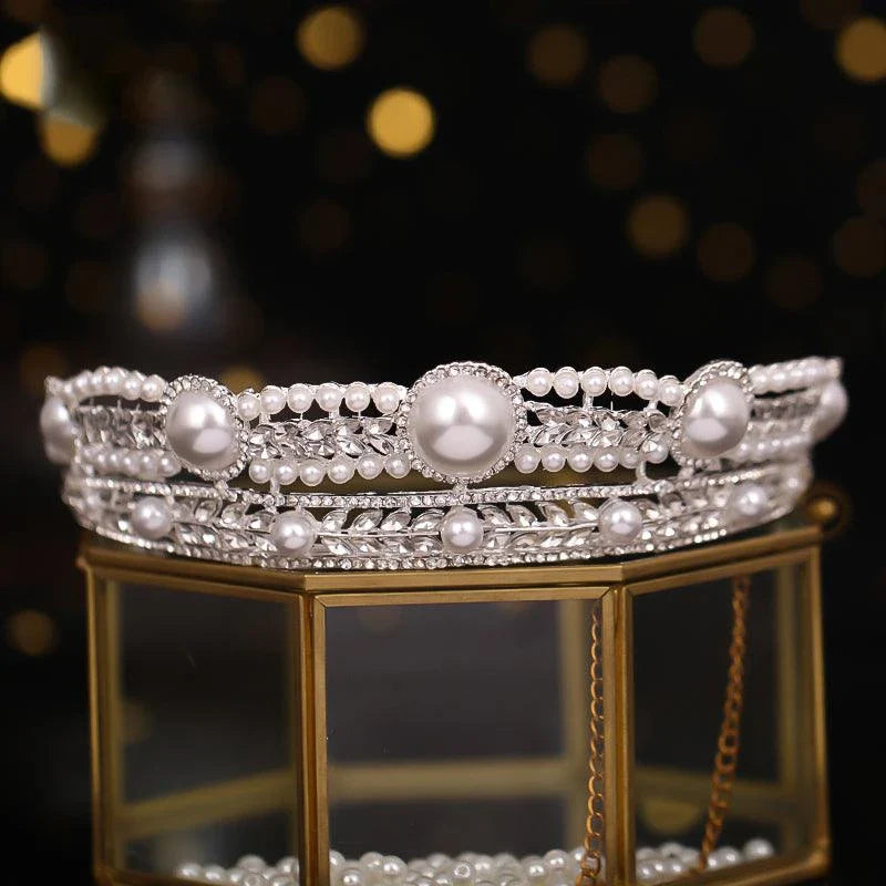 Elegant pearl crown and veil set with intricate silver or gold plated alloy design and sparkling crystal accents, perfect for a fairytale wedding day