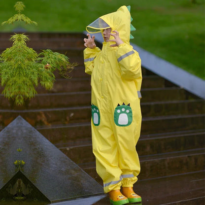 A child wearing a vibrant yellow waterproof raincoat jumpsuit, perfect for playing outdoors in the rain.