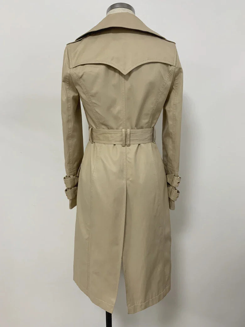 A stylish double-breasted trench coat with a belted waist, made from a cotton-polyester blend for durability and comfort.