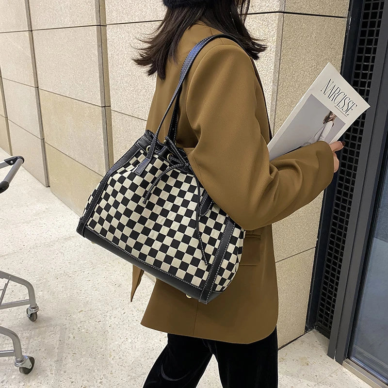 Black PU leather tote bag with a classic checkerboard pattern, perfect for everyday use in the Kiwi lifestyle