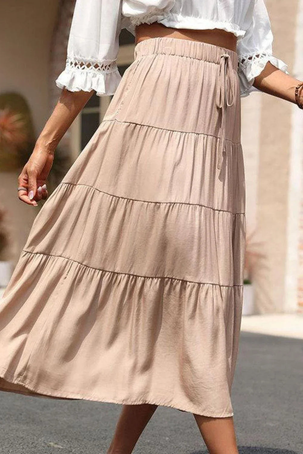 Stylish tiered midi skirt in khaki color with comfortable elastic waistband, made from premium polyester fabric