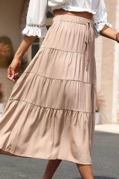 Stylish tiered midi skirt in khaki color with comfortable elastic waistband, made from premium polyester fabric