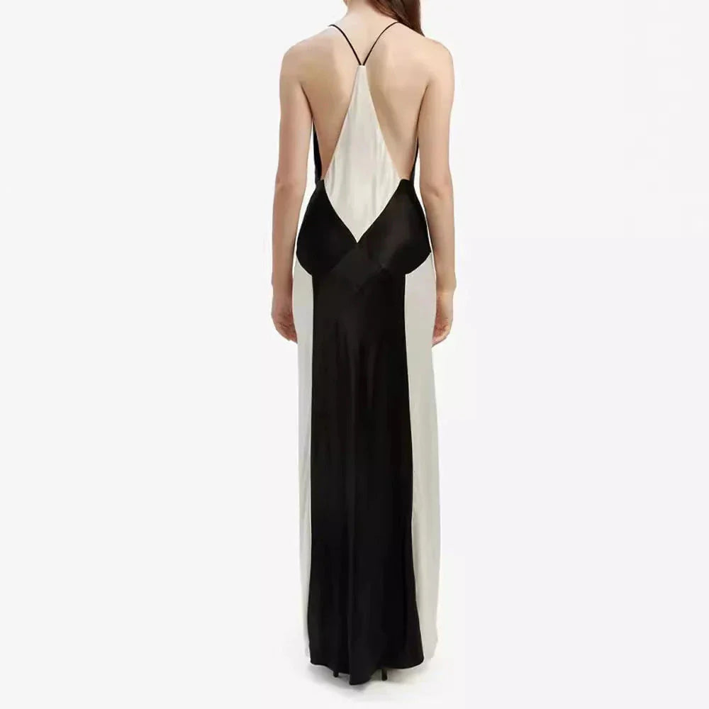 A sleeveless, long sling dress with a geometric black and white pattern, featuring an A-line silhouette and high-waist design.