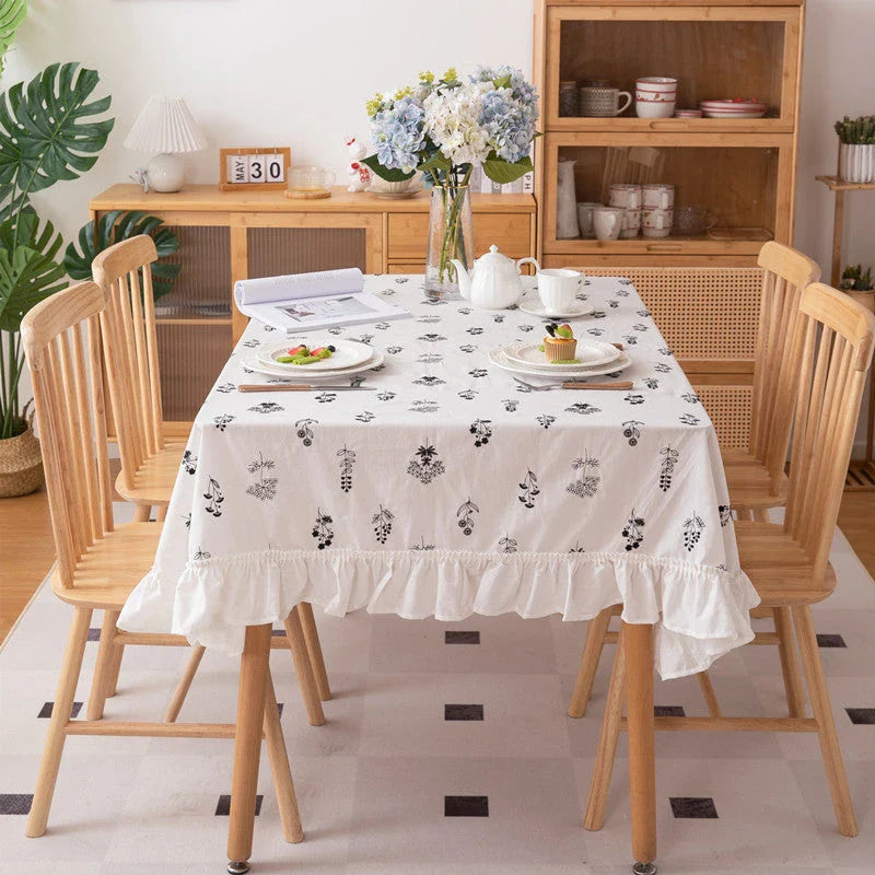 Elegant embroidered floral cotton tablecloth with ruffled edges, perfect for Kiwi homes and hospitality