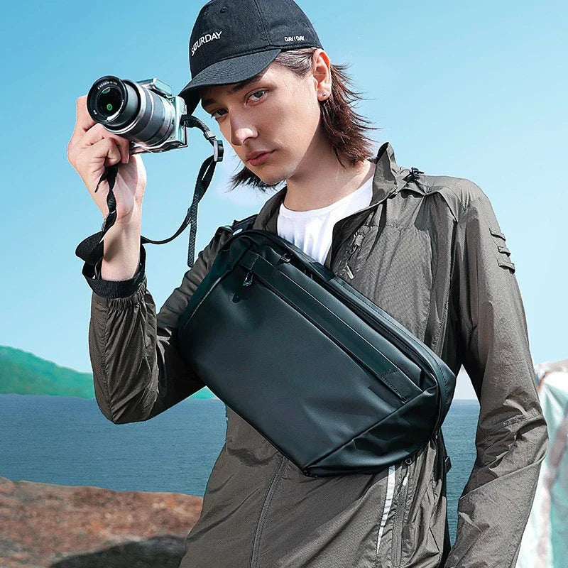 A grey one-shoulder crossbody chest bag with a zippered closure and dedicated pockets for the modern, active Kiwi man