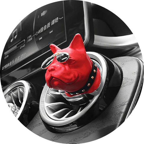 Vibrant red car air freshener in the shape of a bulldog with painted aviator shades and collar