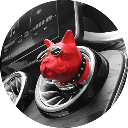 Vibrant red car air freshener in the shape of a bulldog with painted aviator shades and collar