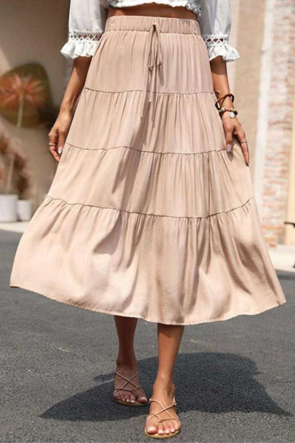 Stylish tiered midi skirt in khaki color with comfortable elastic waistband, made from premium polyester fabric