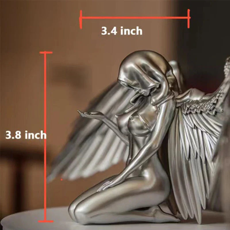 A silver resin ornament featuring the graceful silhouette of angel wings, perfect for adding a touch of Kiwi charm to your home decor.