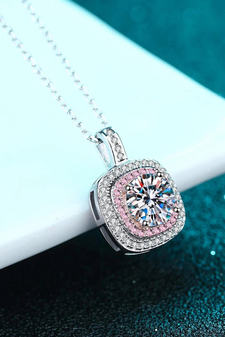 A sterling silver geometric pendant necklace featuring a radiant Moissanite centre stone and accented with shimmering zircon stones