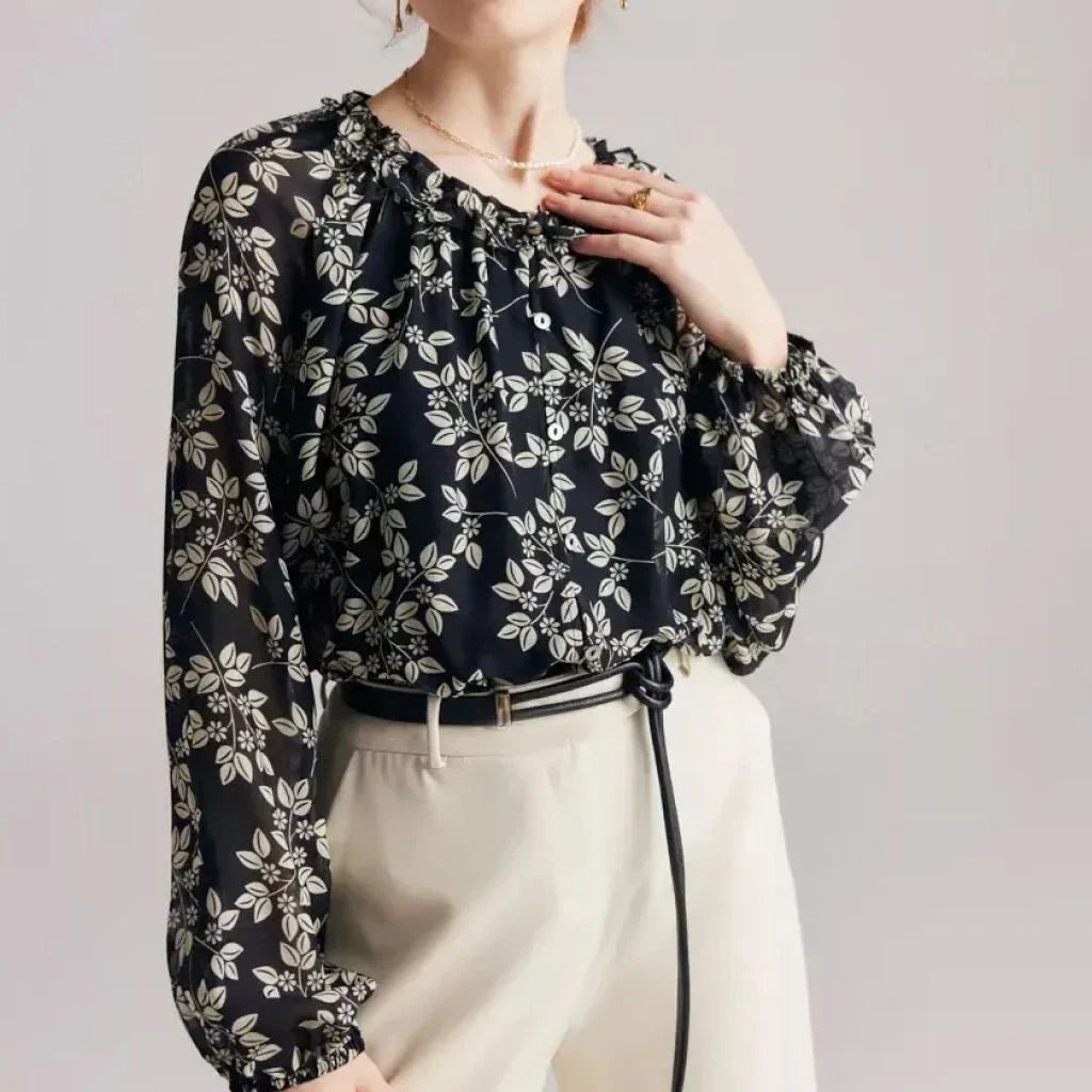 Elegant floral silk-blend blouse with ruffled details and relaxed raglan sleeves