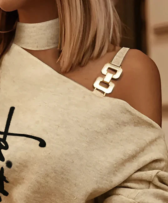 Stylish diagonal shoulder chain embellished long sleeve top in black, perfect for casual Kiwi-inspired fashion