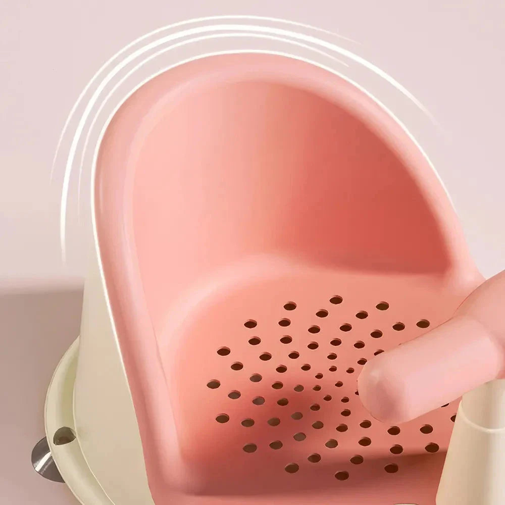 A green, ergonomically designed infant bath tub with large suction cups on the bottom to prevent slipping or tipping.