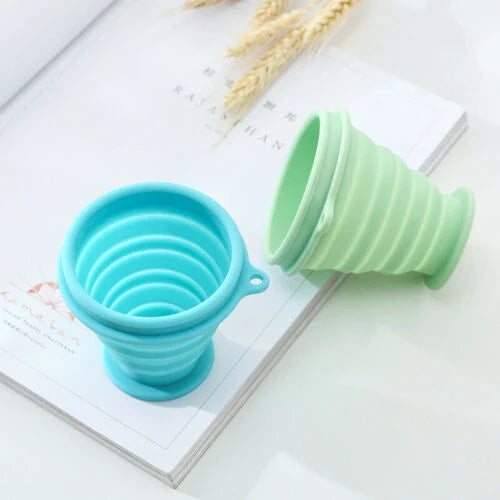 Compact, collapsible silicone cup in various colors, perfect for Kiwi travelers and adventurers