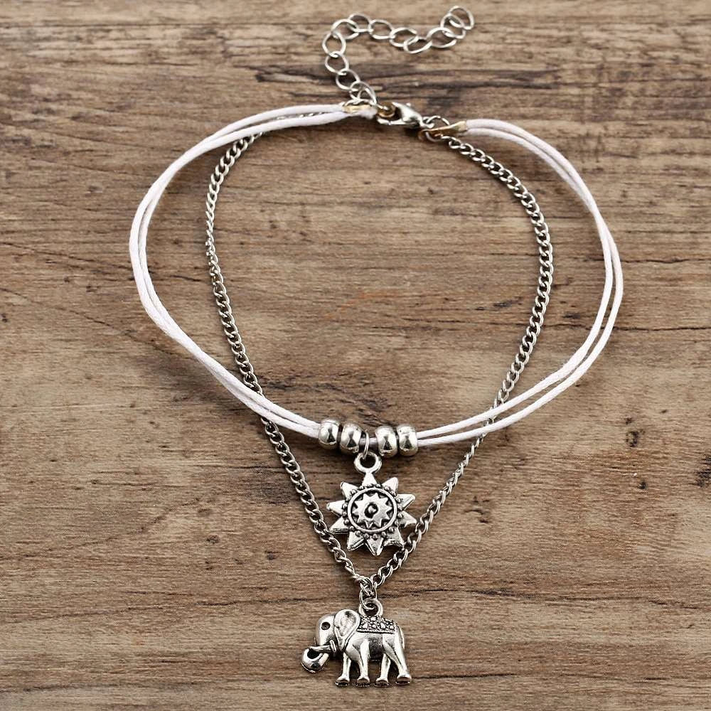 Bohemian-style anklet with star and elephant pendant charms, made from durable zinc alloy in shimmering silver and gold tones