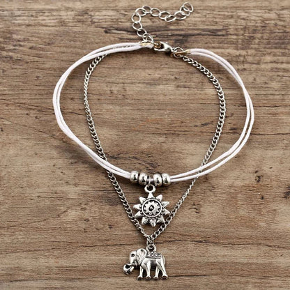 Bohemian-style anklet with star and elephant pendant charms, made from durable zinc alloy in shimmering silver and gold tones