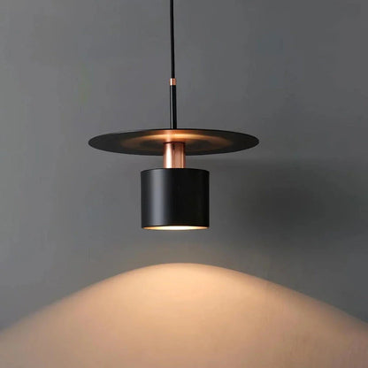 A modern, minimalist pendant light with a sleek, painted metal design, perfect for enhancing the ambiance of cafes, bedrooms, and other contemporary interior spaces.