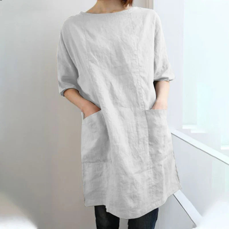 A cotton and linen dress with a round neckline, pockets, and an A-line silhouette in various colors.