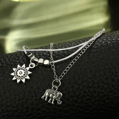 Bohemian-style anklet with star and elephant pendant charms, made from durable zinc alloy in shimmering silver and gold tones