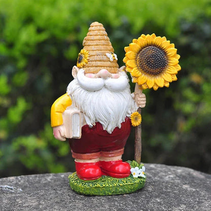 A charming resin garden gnome statue holding a sunflower and book, designed to brighten up any Kiwi outdoor space.